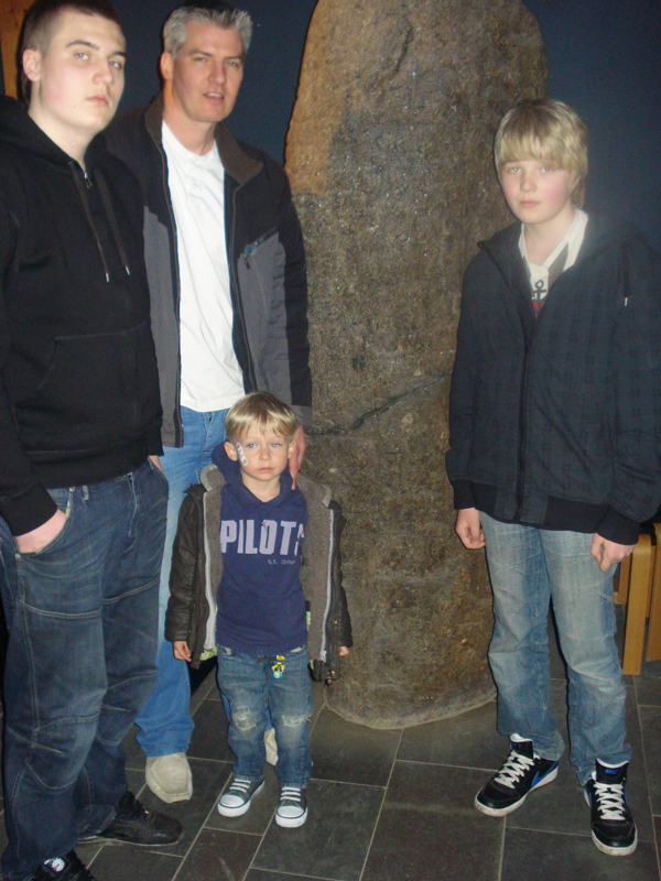 Steffen and his three sons, Tiemo, Lukas and Silas, with the large Sigtrygg rune in Haitabu.